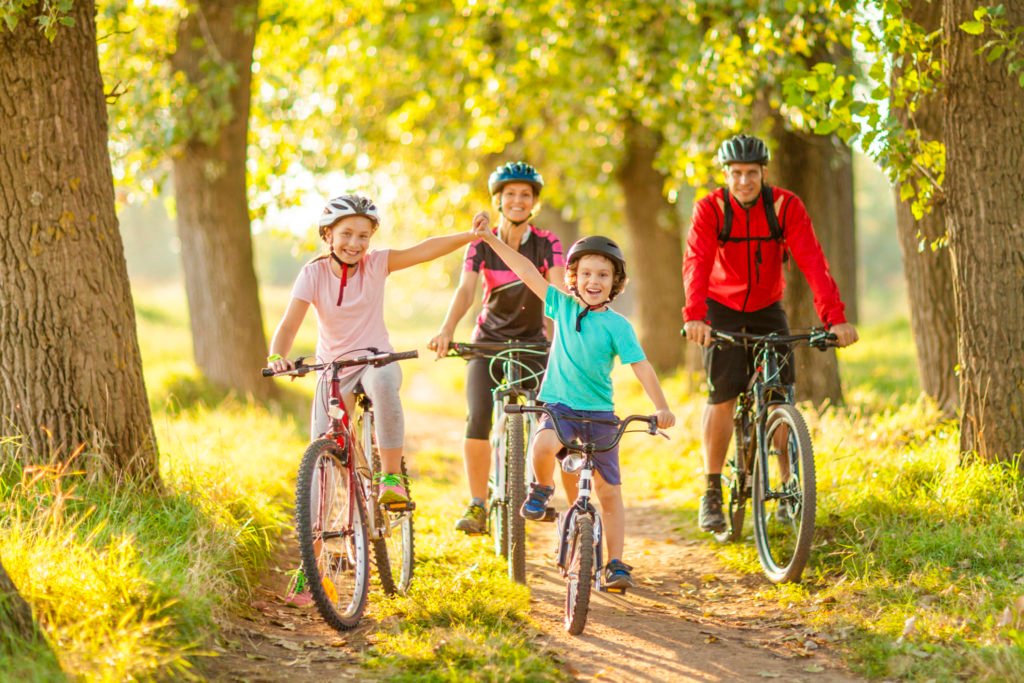 happy family cycling in the countryside